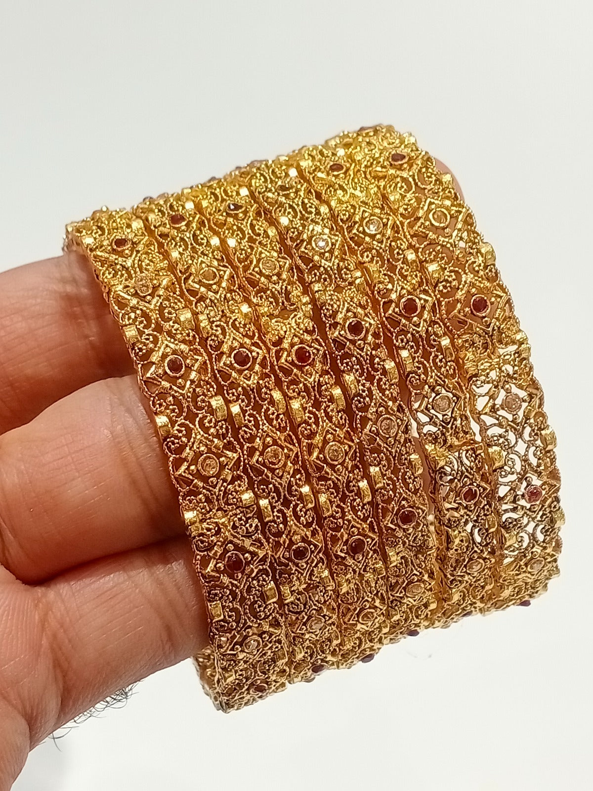 Gold filigree bridal bangles with ruby stones - front view