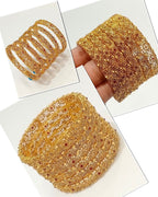 Gold filigree bridal bangles with ruby stones - close up hand view